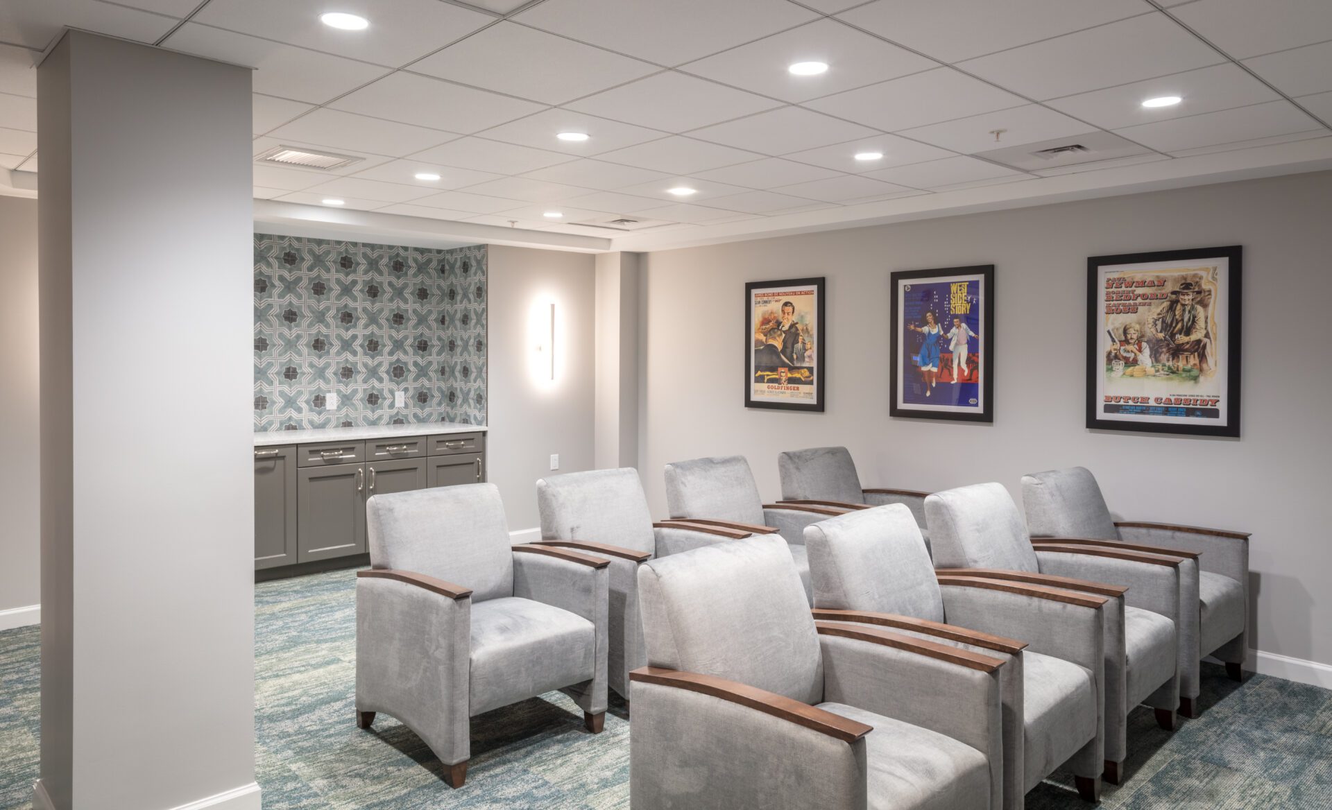 Modern waiting area with gray chairs and framed posters on the wall