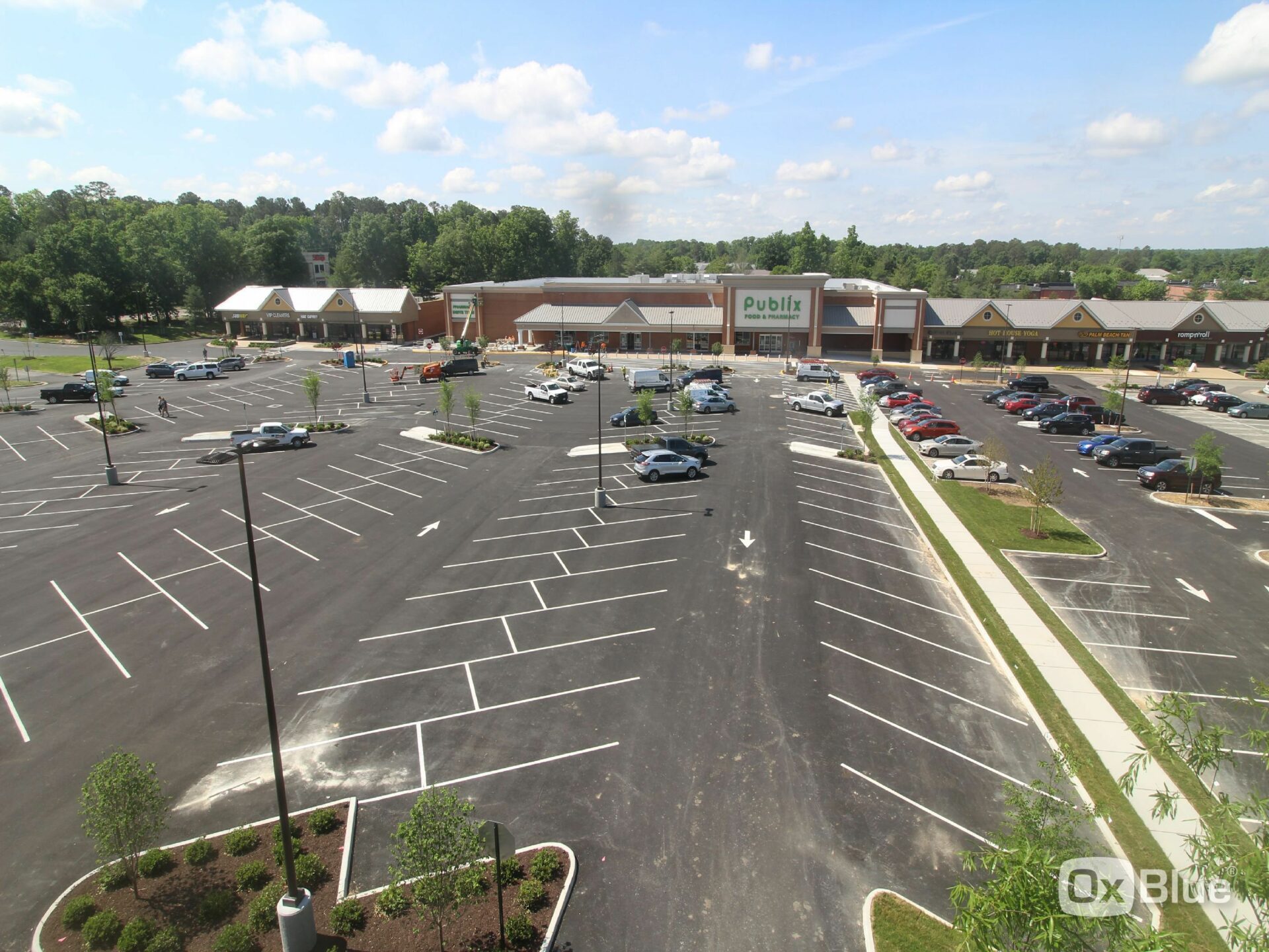 Aerial view of a Publix supermarket with a large parking lot on a sunny day